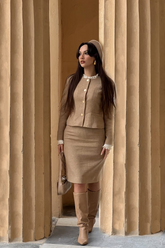 a lady in a brown wool jacket and a brown wool skirt